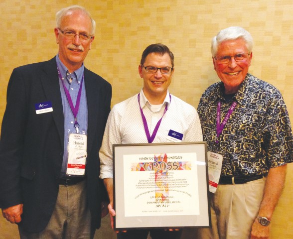 Cooperative Baptist Fellowship Heartland Associate Coordinator Jeff Langford (center) holds the award presented by Moderator Michael Olmsted (right). At left is Harold Phillips, CBF Heartland coordinator. (Photo by Bill Webb)