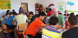 Cooperative Baptist Fellowship Heartland Coordinator Harold Phillips (right, facing) works with students in a school in Vazec, Slovakia. A Heartland team served the local school and developed relationships with Roma (Gypsy) children from a nearby settlement. (CBF Heartland photo)