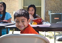 School-age children enjoy a free meal at a summer meals site in Alamo, Texas.
