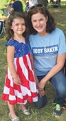 Judy Baker, candidate for Missouri treasurer, visits with a young girl during a Labor Day event.