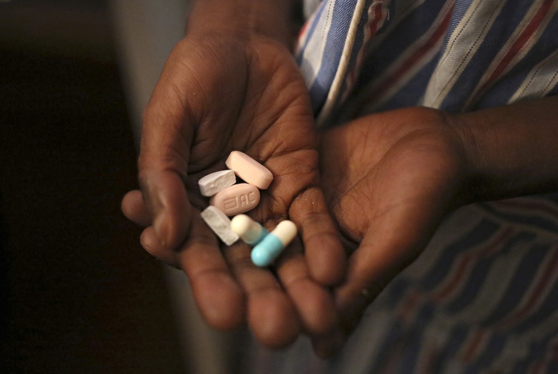 Nine-year-old Tumelo shows off antiretroviral pills before taking his medication at Nkosi’s Haven, south of Johannesburg, South Africa, on Nov. 28, 2014. Nkosi’s Haven provides residential care for destitute HIV-positive mothers and their children, whether HIV-positive or not. Photo by Siphiwe Sibeko/Reuters
