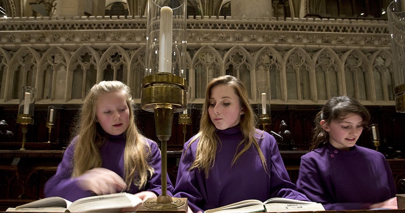 From left, choristers Abby Cox, Poppy Braddy and Chloe Chawner practice for an evensong performance on Jan. 22, 2014, in Canterbury Cathedral in Canterbury, England. The singers were part of the first all-female choir to perform at the cathedral, ending the centuries-old all-male tradition. (AP Photo/Alastair Grant)