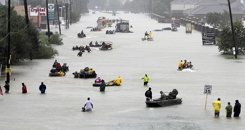 Rescue boats fill a flooded street as people are evacuated as floodwaters from Tropical Storm Harvey rise on Aug. 28, 2017, in Houston. (AP Photo/David J. Phillip)