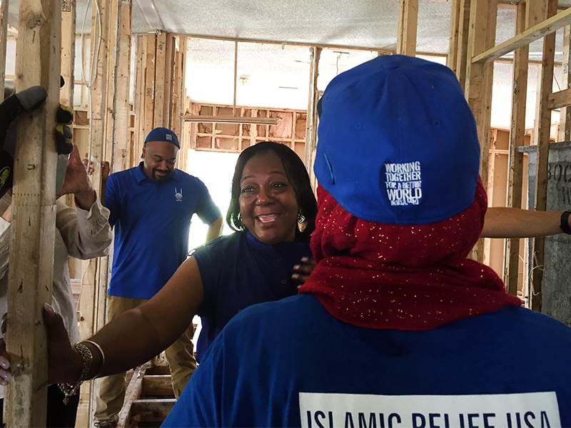 Delores J. Porter hugs each of the volunteers from Islamic Relief USA who worked in her home in Princeville, N.C. RNS photo by Yonat Shimron