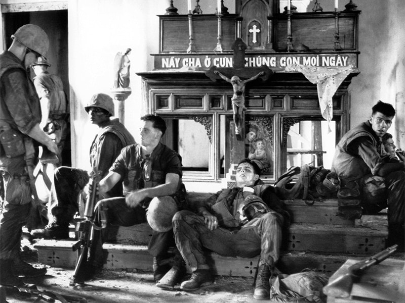 U.S. Marines, weary from battling North Vietnamese, rest at the altar of an abandoned Roman Catholic church south of Con Thien in South Vietnam on May 16, 1967. (AP Photo)