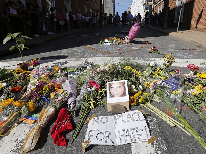 A makeshift memorial of flowers and a photo of victim Heather Heyer sits in Charlottesville, Va., on Aug. 13, 2017. Heyer died when a car rammed into a group of people who were protesting the presence of white supremacists who had gathered in the city for a rally. AP Photo/Steve Helber