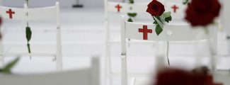 A memorial for the victims of the shooting at Sutherland Springs First Baptist Church, including 26 white chairs each painted with a cross and and rose, is displayed in the church Sunday, Nov. 12, 2017, in Sutherland Springs, Texas. A man opened fire inside the church in the small South Texas community last week, killing more than two dozen. (AP Photo/Eric Gay)