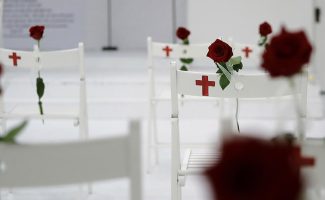 A memorial for the victims of the shooting at Sutherland Springs First Baptist Church, including 26 white chairs each painted with a cross and and rose, is displayed in the church Sunday, Nov. 12, 2017, in Sutherland Springs, Texas. A man opened fire inside the church in the small South Texas community last week, killing more than two dozen. (AP Photo/Eric Gay)