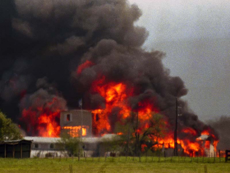 Fire engulfs the Branch Davidian compound near Waco, Texas, on April 19, 1993. The compound burned to the ground after FBI agents in an armored vehicle smashed the buildings and pumped in tear gas. The Justice Department said cult members set the fire. (AP Photo/Ron Heflin)