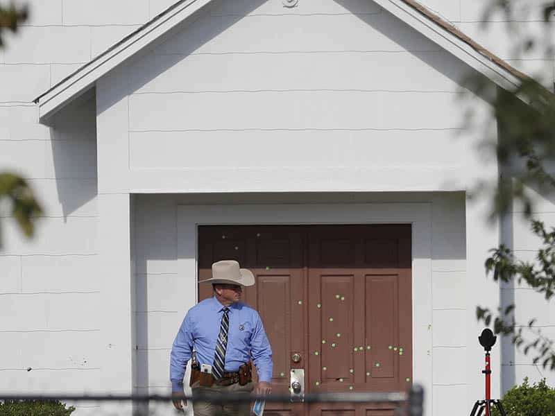 A law enforcement official leaves the First Baptist Church on Nov. 7, 2017, in Sutherland Springs, Texas. A man opened fire inside the church in the small South Texas community on Sunday, killing more than two dozen and injuring others. (AP Photo/David J. Phillip)
