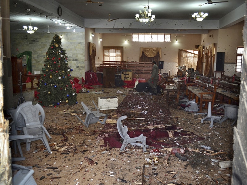 A Pakistani walks in the main hall of a church following a suicide attack in Quetta, Pakistan, Sunday, Dec. 17, 2017. Two suicide bombers attacked the church when hundreds of worshippers were attending services at the church ahead of Christmas. (AP Photo/Arshad Butt)