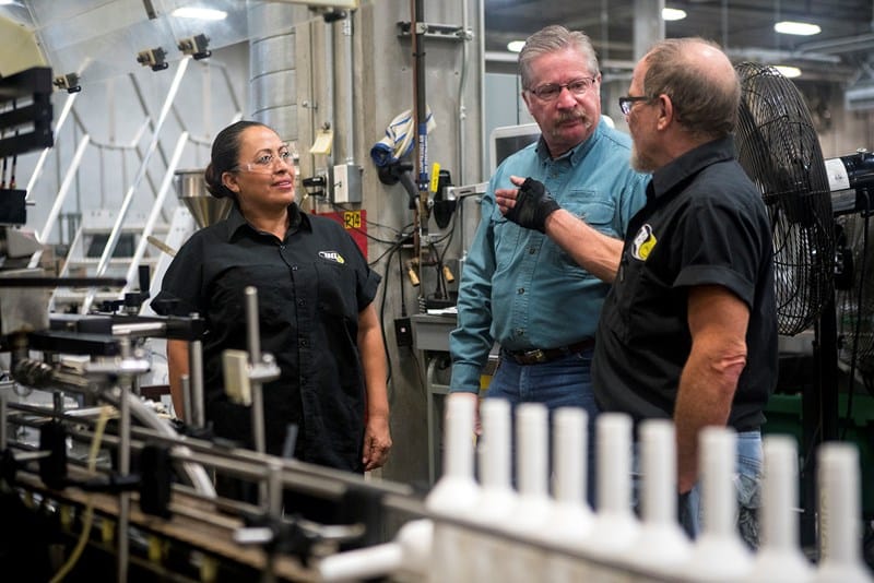 Talking to Elsa Wells and Cory Kroeker (right) and everyone else is Don Mayberry's goal when the bivocational cowboy church pastor goes to work at one of three BG Products facilities in Kansas -- conversations that lead to more serious talks back in the chaplain's office. (Photo: Sue Sprenkle)