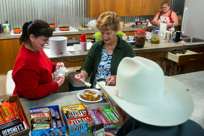 Sherry Mayberry (left) works in the kitchen with other volunteers at Three Wooden Crosses. She and her husband Don, bivocational pastor of the cowboy church, spend many evenings and most weekends in ministry since they also hold second jobs. (Photo: Sue Sprenkle)
