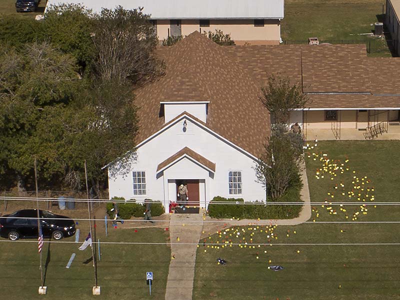 Flags mark evidence on the lawn of the First Baptist Church in Sutherland Springs, Texas, on Nov. 6, 2017, a day after over 20 people died in a mass shooting. (Jay Janner/Austin American-Statesman via AP; caption amended by RNS)