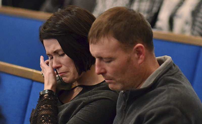 A woman wipes tears from her eye during a prayer vigil at Briensburg Baptist Church near Benton, Ky., on Tuesday, Jan. 23, 2018. Bailey Nicole Holt and Preston Ryan Cope, both 15, were killed and another 17 people injured when a classmate opened fire Tuesday morning in the Marshall County High School atrium, a common area at the school where several hallways meet and students gather before classes. (AP Photo/Stephen Lance Dennee)