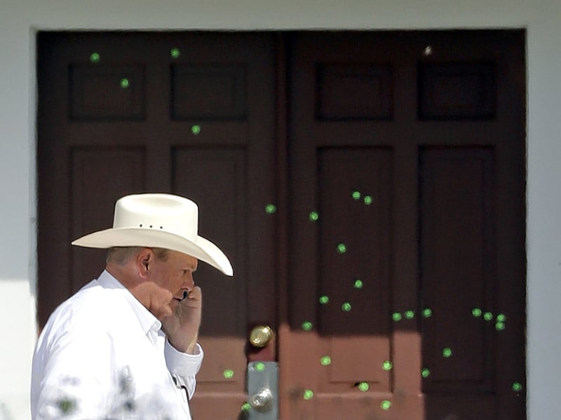 Wilson County Sheriff Joe Tackitt Jr. walks past the front doors where bullet holes were marked by police at the First Baptist Church, on Nov. 7, 2017, in Sutherland Springs, Texas. (AP Photo/David J. Phillip; caption amended by RNS)