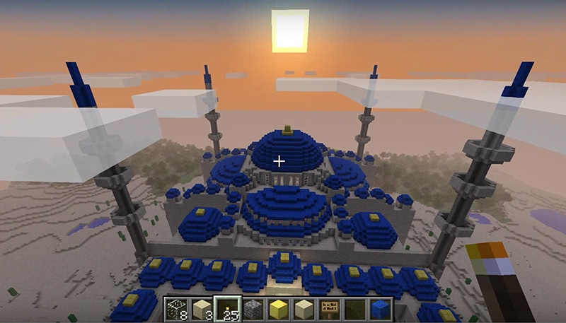 An aerial sunset view of a Blue Mosque creation in Minecraft from the player point of view. Screenshot from YouTube