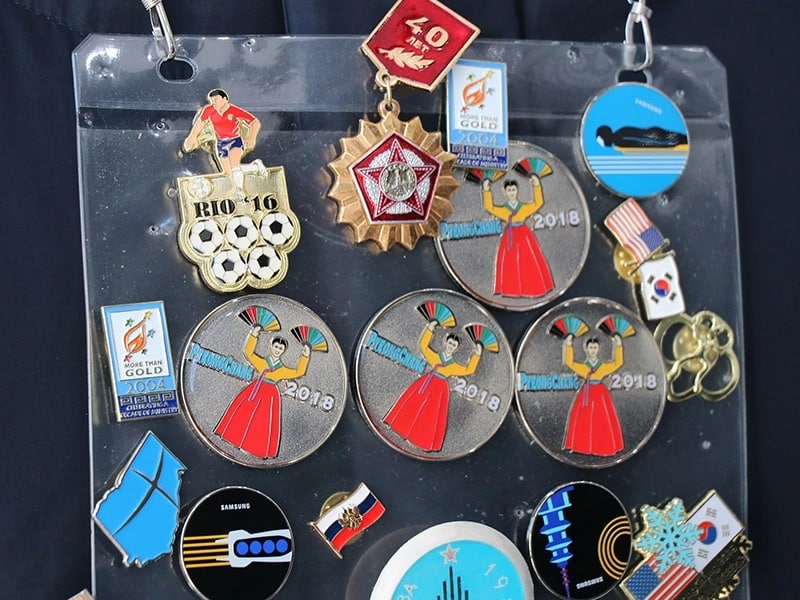 Trading lapel pins is one strategy missionaries use to start discussions with Olympic athletes and visitors in South Korea for the games. (RNS photo: Madeline C. Mulkey)