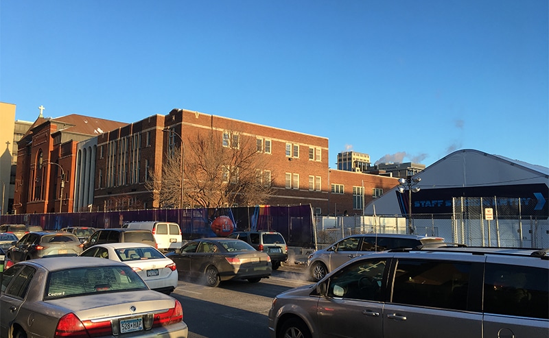 First Covenant Church on 7th Street in downtown Minneapolis is wrapped by security fencing and is hosting a large hospitality tent, right, for Super Bowl staff in Minneapolis, Minn. (Photo: Dan Collison)