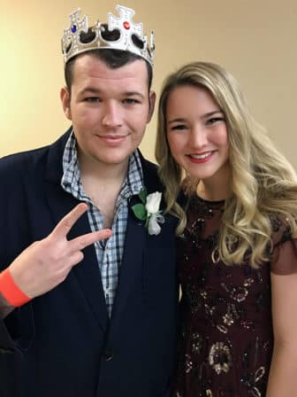 “King” Arthur Jennings, 27, left, with his volunteer buddy Addison Paxton, a University of Oklahoma student, is a big fan of Tim Tebow, even though he cheers for the OU Sooners. Jennings was looking forward to dancing at the “Night to Shine” event hosted by the Putnam City Baptist Church in Oklahoma City on Feb. 9, 2018. RNS photo by Bobby Ross Jr.