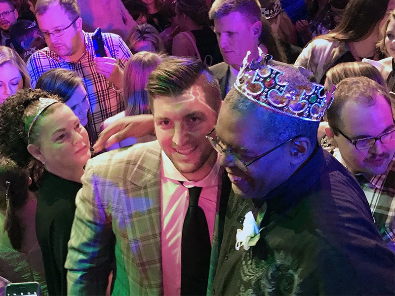 Tim Tebow, center, surprises participants and volunteers Feb. 9, 2018, at the “Night to Shine” prom experience at the Putnam City Baptist Church in Oklahoma City. Tebow’s foundation sponsored simultaneous Night to Shine events for special-needs teens and adults at 537 churches in all 50 states and 16 countries. RNS photo by Bobby Ross Jr.