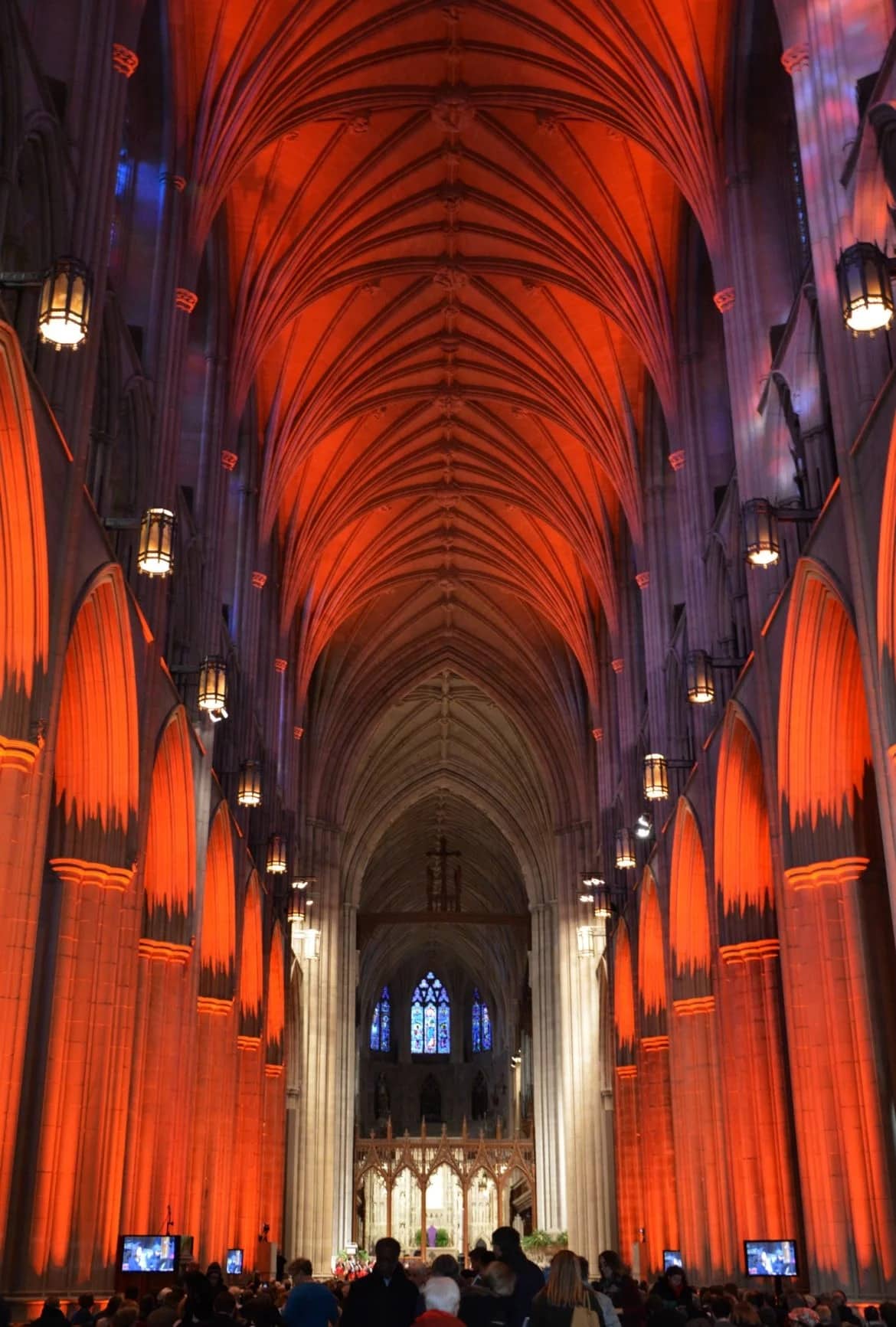 Orange lights illuminate the Washington National Cathedral during a vigil for gun violence victims on March 23, 2018. The vigil was held ahead of the March for Our Lives demonstration. RNS photo by Jack Jenkins.