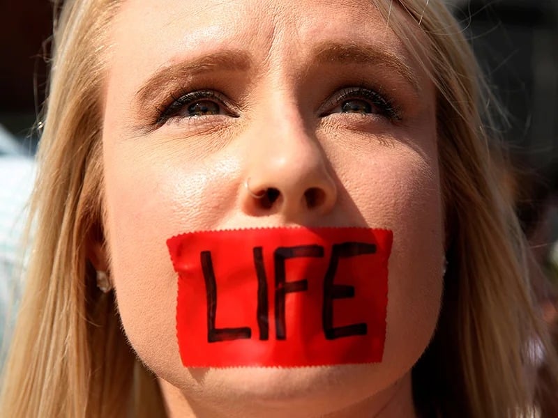An anti-abortion protester with tape over her mouth demonstrates outside the U.S. Supreme Court in Washington on June 27, 2016. (Kevin Lamarque/Reuters)