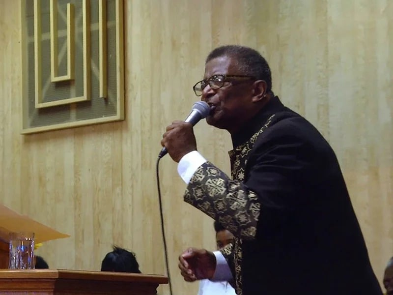 Pastor Vernal Harris preaches to his congregation in upstate New York. Along with wife, Narseary, he struggles with his faith following the loss of their two sons. Photo by Paul Sanderson/”Into the Night: Portraits of Life and Death”