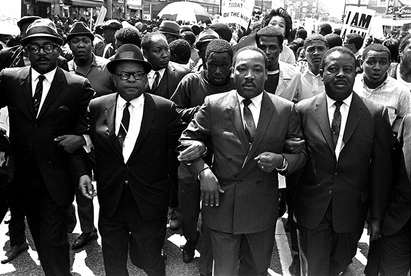 The Rev. Ralph Abernathy, right, and Bishop Julian Smith, left, flank the Rev. Martin Luther King Jr. during a civil rights march in Memphis, Tenn., on March 28, 1968. (AP Photo/Jack Thornell)