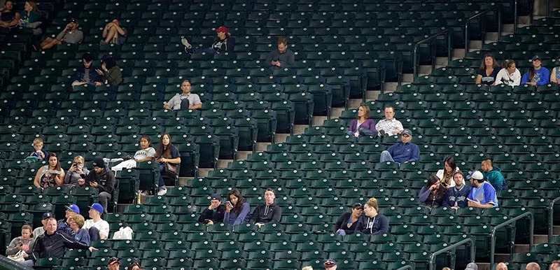 Large sections of empty seats are shown during the sixth inning of a baseball game between the Seattle Mariners and the Texas Rangers at Safeco Field, on Sept. 8, 2015, in Seattle. The announced attendance of 13,389 was the smallest home crowd of the 2015 season for the Mariners. Many MLB teams struggle with low attendance. (AP Photo/Ted S. Warren)
