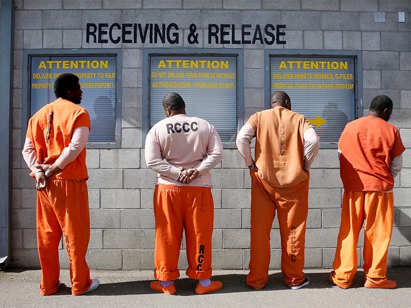Prisoners from Sacramento County await processing after arriving at the Deuel Vocational Institution in Tracy, Calif., on Feb. 20, 2014. (AP Photo/Rich Pedroncelli)
