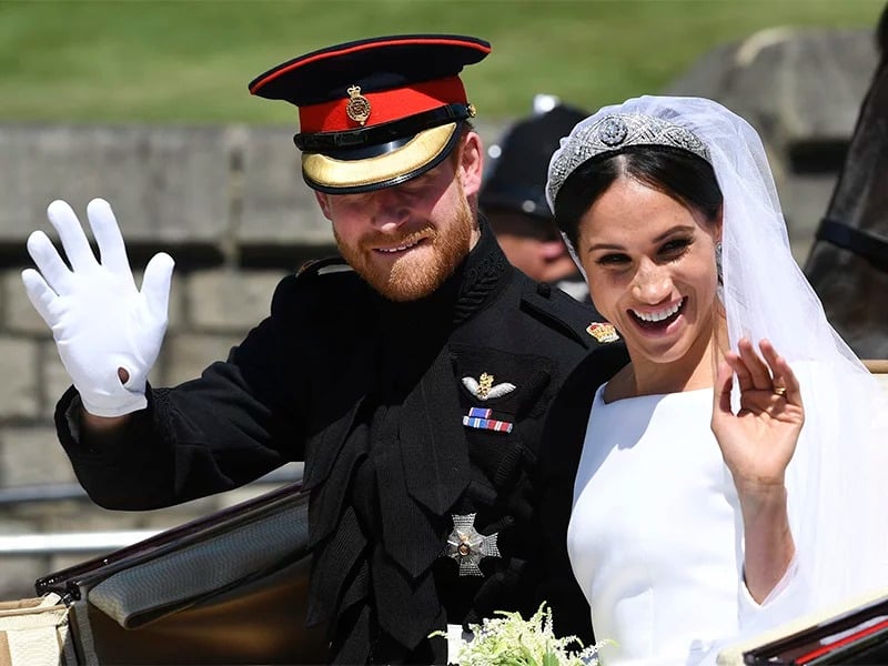 Britain’s Prince Harry, Duke of Sussex, and his wife, Meghan Markle, Duchess of Sussex, wave from the Ascot Landau Carriage during their carriage procession on Castle Hill outside Windsor Castle in Windsor, England, after their wedding ceremony on May 19, 2018. (Paul Ellis/pool photo via AP)