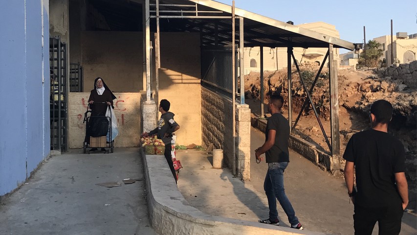 A nun walks through the Hebron Road Checkpoint in Bethlehem, West Bank, on June 5, 2018. RNS photo by Dan Rabb