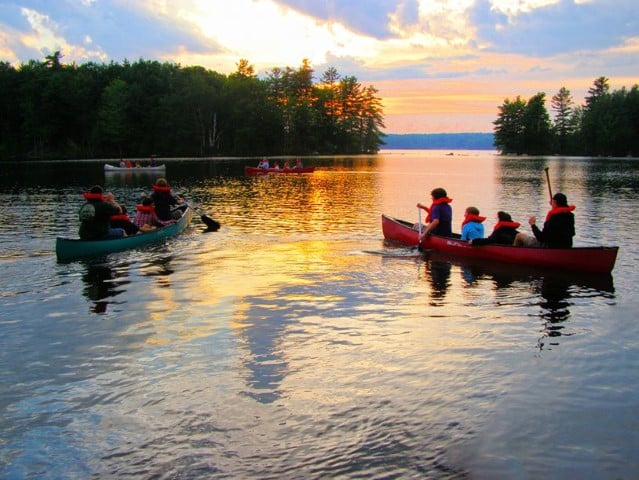 Campers canoe on Cobboseecontee Lake at Pilgrim Lodge in Maine. Photo by Lydia Hoffman/Pilgrim Lodge