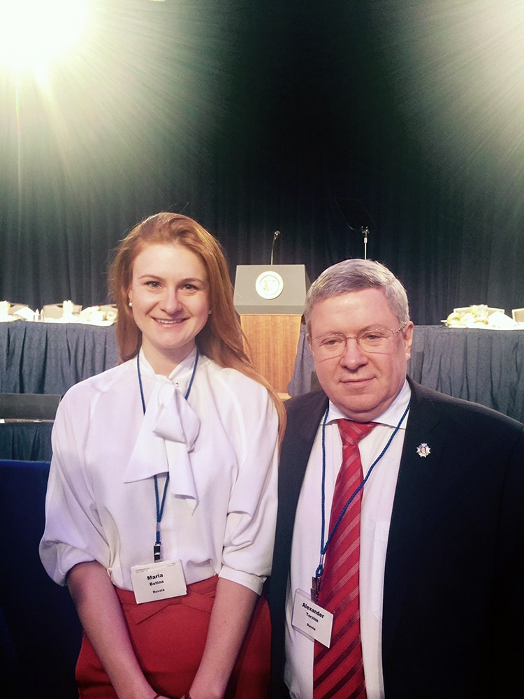 Alleged Russian agent Mariia Butina, left, and Russian politician Alexander Torshin at the 2017 National Prayer Breakfast. President Trump spoke from the podium in the background. Photo via Facebook