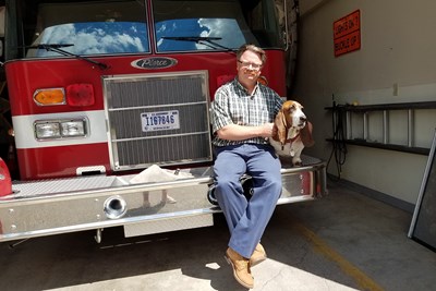 Britton Gray, Yellowstone National Park's structural fire chief, responsible for 1,600 buildings, including lodging for 20,000 guests, serves as bivocational pastor of Gardiner Baptist Church near the north entrance to the nation's oldest park. Here he rests with his near-constant companion, fire dog Magoo. Photo by Karen Willoughby