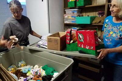 Linda Gray and Sue Oliver check some of the stuffed animals that have already been given for Gardiner Baptist Church's 2018 Operation Christmas Child shoeboxes. Gray is the wife of pastor Britton Gray; Oliver is the Montana church's supplies coordinator for the yearly project. Photo by Karen Willoughby