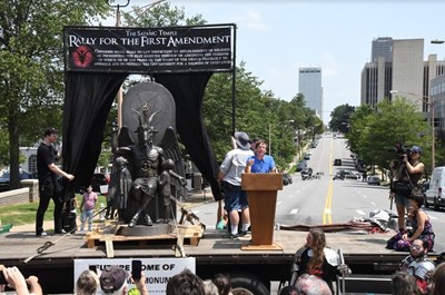 LeeWood Thomas, right, co-founder of the Arkansas Society of Freethinkers, speaks during the Satanic Temple's Rally for the First Amendment Aug. 16 on the steps of the Arkansas State Capitol in Little Rock. Photo by Caleb Yarbrough