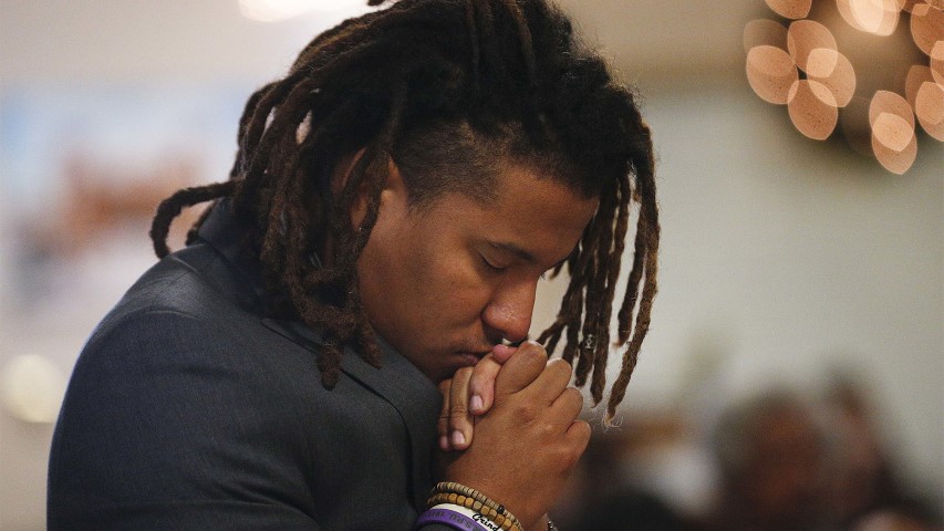 Jeremiah Chapman prays during a 16th Street Baptist Church service on Dec. 10, 2017, in Birmingham, Ala. (AP Photo/Brynn Anderson)