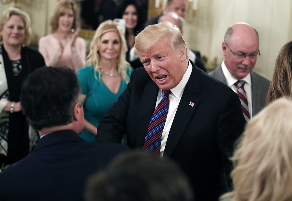 President Trump greets people as he arrives to speak during a dinner for evangelical leaders in the State Dining Room of the White House on Aug. 27, 2018, in Washington. (AP Photo/Alex Brandon)