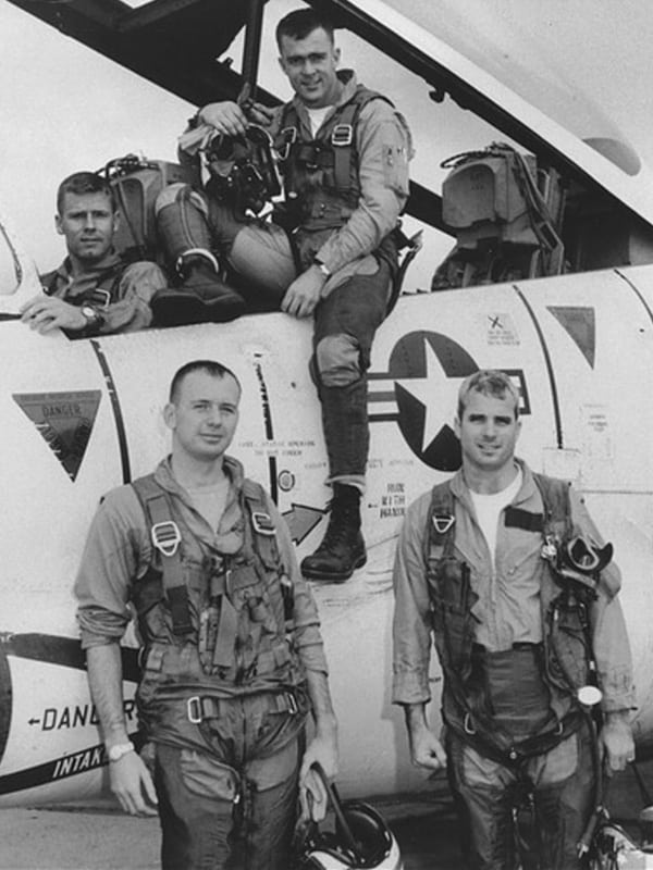John McCain, front right, with his squadron and T-2 Buckeye trainer in 1965. Photo courtesy of Creative Commons