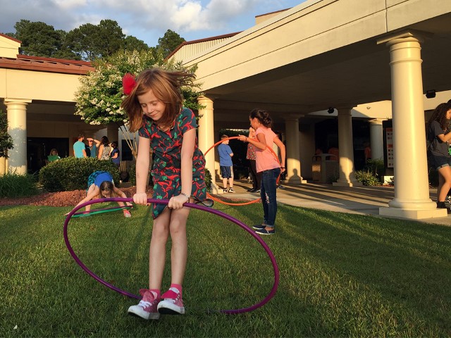 Girls twirl hoola hoops outside Manna Church following a Thursday evening service in Fayetteville, N.C. RNS photo by Yonat Shimron