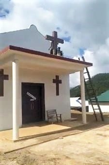 A United Wa State Army (UWSA) militant begins toppling cross on church building in rebel-held territory in Shan state, Burma (Myanmar), in photo circulated on Facebook. Morning Star News via Facebook