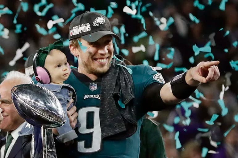 Philadelphia Eagles quarterback Nick Foles holds his daughter, Lily, after beating the New England Patriots in the NFL Super Bowl 52 football game on Feb. 4, 2018, in Minneapolis. Foles, who was named the Super Bowl MVP, is an online graduate student at Liberty University, earning his master’s degree in divinity. (AP Photo/Frank Franklin II)
