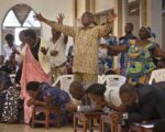 Rwandans sing and pray at the Evangelical Restoration Church in the Kimisagara neighborhood of the capital, Kigali, Rwanda, on April 6, 2014. Rwanda's government has closed numerous churches and mosques in 2018 as it seeks to assert more control over a vibrant religious community whose sometimes makeshift operations, authorities say, have threatened the lives of followers. (AP Photo/Ben Curtis)