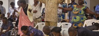 Rwandans sing and pray at the Evangelical Restoration Church in the Kimisagara neighborhood of the capital, Kigali, Rwanda, on April 6, 2014. Rwanda's government has closed numerous churches and mosques in 2018 as it seeks to assert more control over a vibrant religious community whose sometimes makeshift operations, authorities say, have threatened the lives of followers. (AP Photo/Ben Curtis)