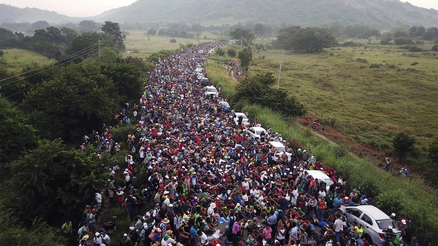 Members of a U.S.-bound migrant caravan stand on a road after federal police briefly blocked their way outside the town of Arriaga, Mexico, on Oct. 27, 2018. Hundreds of Mexican federal officers carrying plastic shields had blocked the caravan from advancing toward the United States after several thousand of the migrants turned down the chance to apply for refugee status and obtain a Mexican offer of benefits. (AP Photo/Rodrigo Abd)
