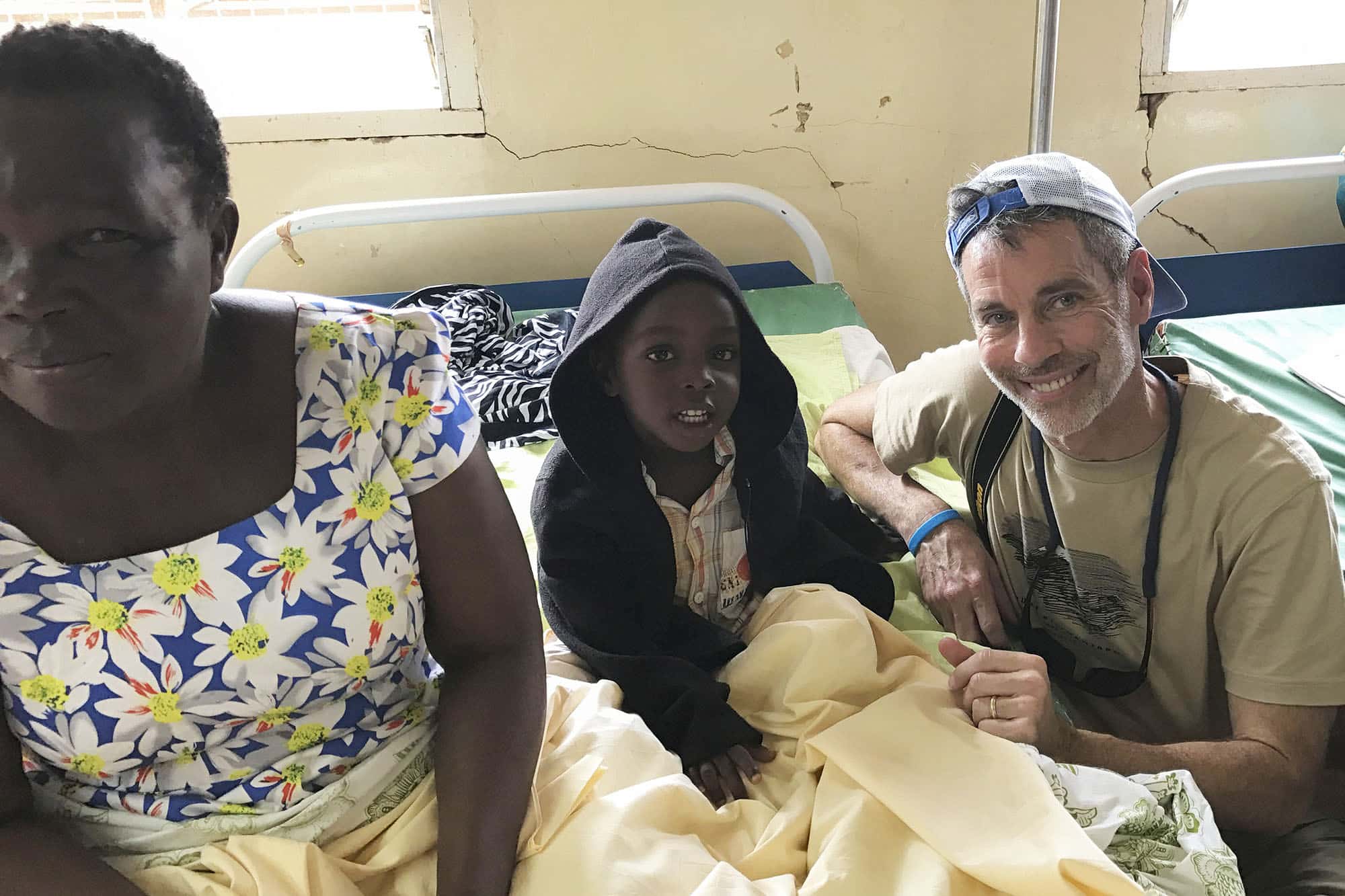 Scott Swedenburg (right), a member of Dawson Memorial Baptist Church in Birmingham, Ala., visits with a patient at Kigoma Baptist Hospital in Tanzania. After seeing the hospital's great need for more space a few years ago, the church helped build a new pediatric wing to further the hospital's ministry. IMB photo