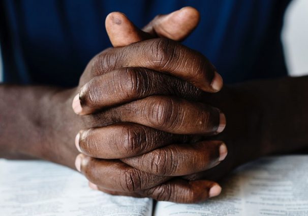 praying hands on Bible