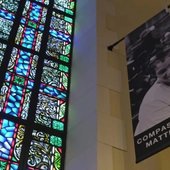 stained glass and compassion banner